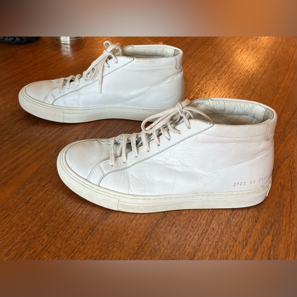COMMON PROJECTS
Original Achilles Mid Sneakers in White. Size 38 Women’s.